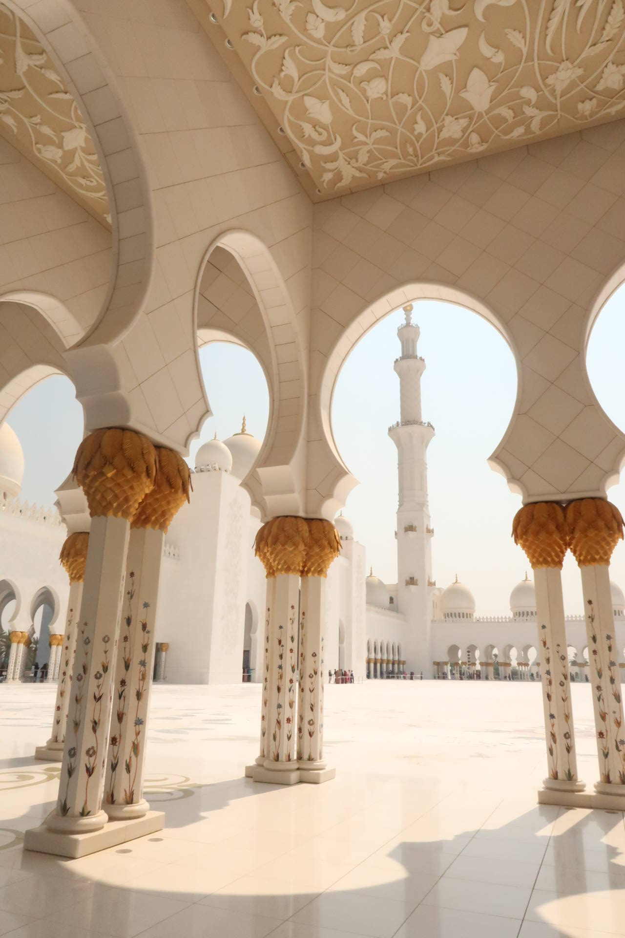 archway shot of turret in mosque made of white marble 