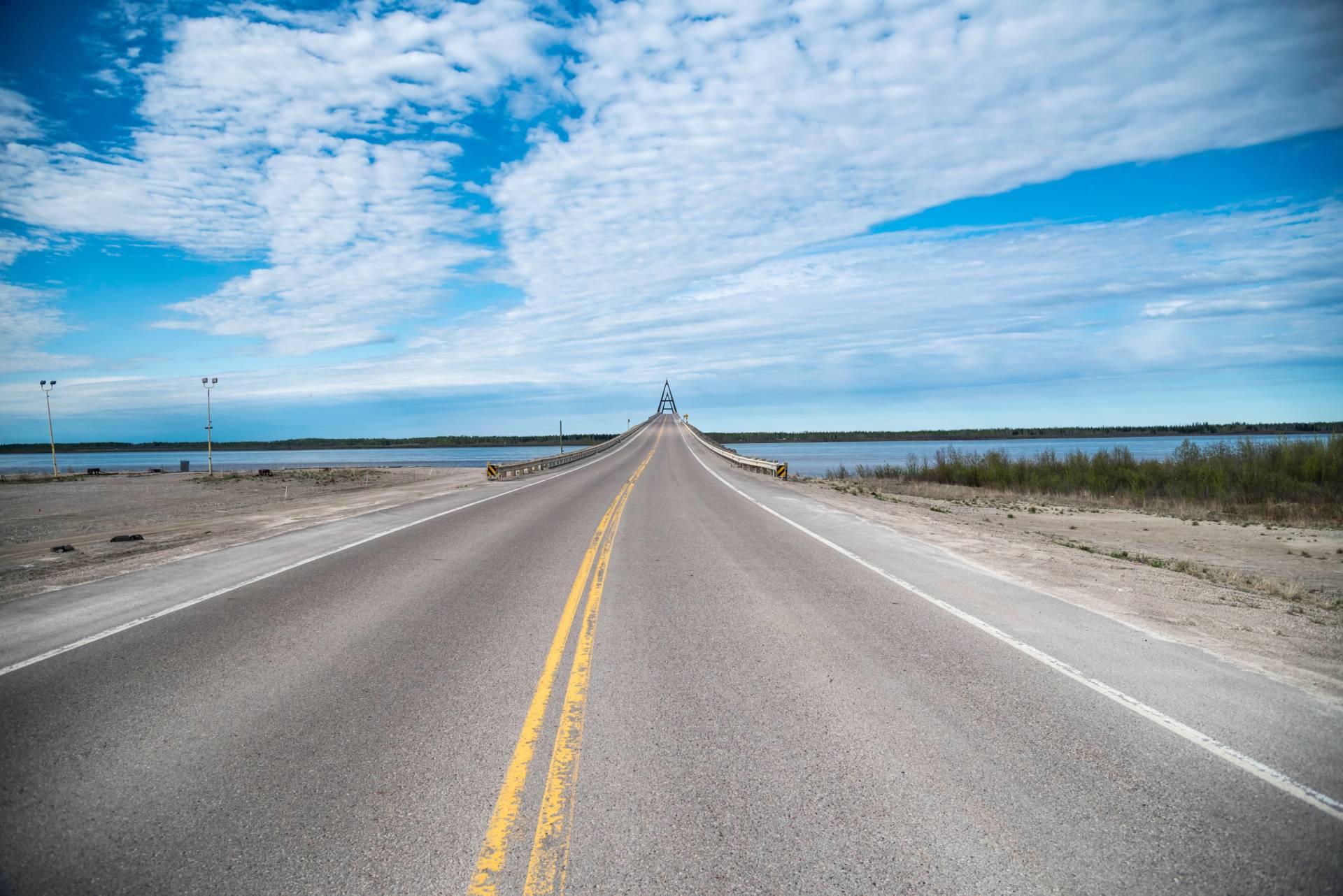 gray asphalt road under white clouds