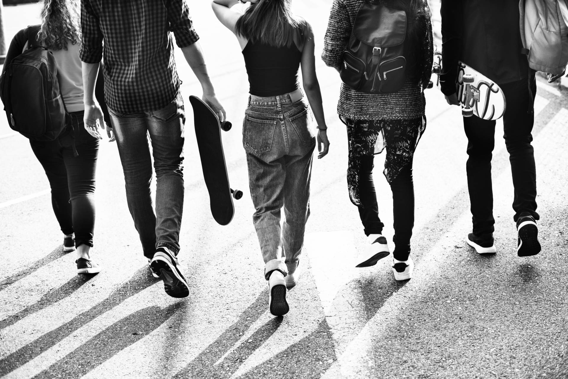 Greyscale photo of teens on street