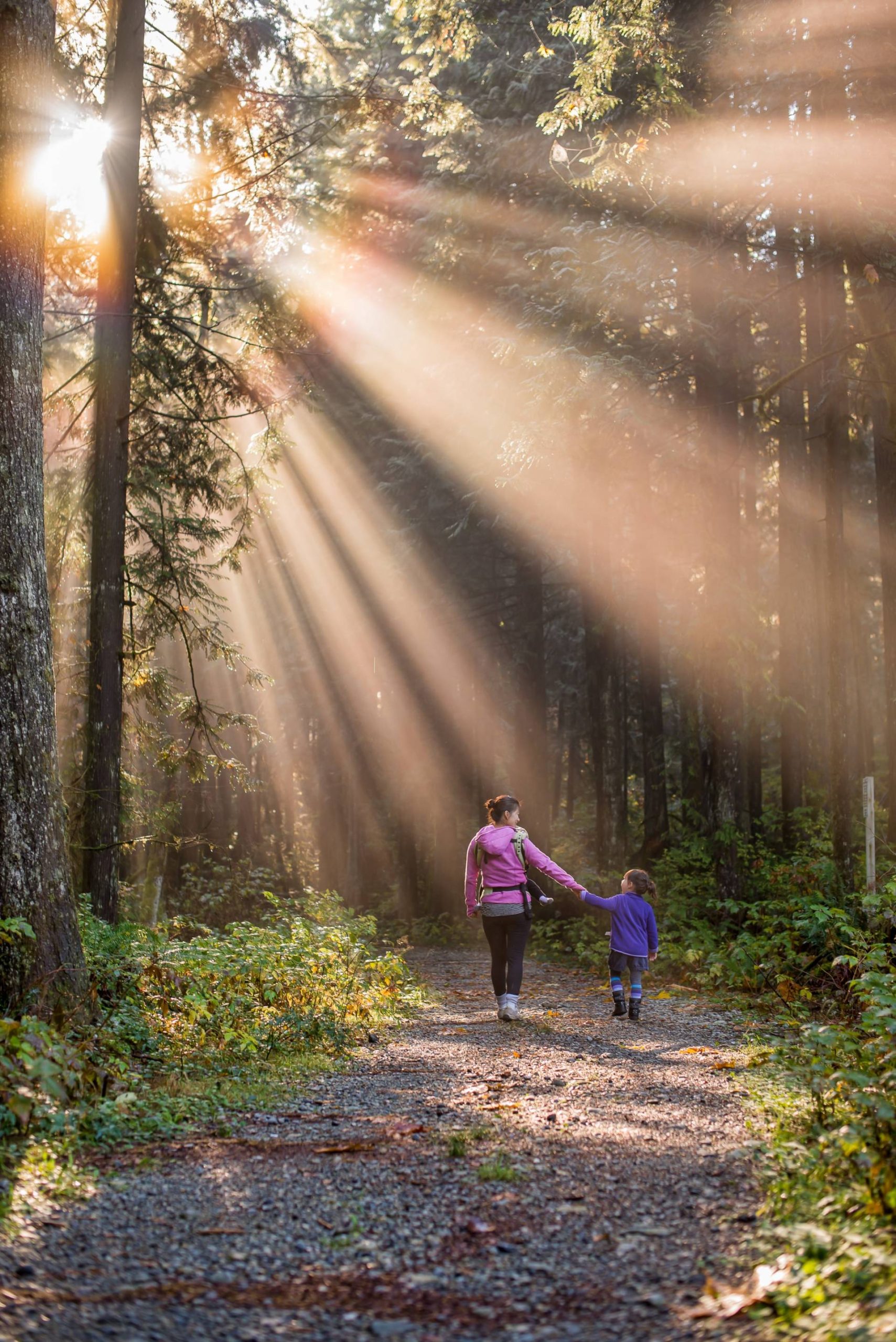 woman walking in forest with child