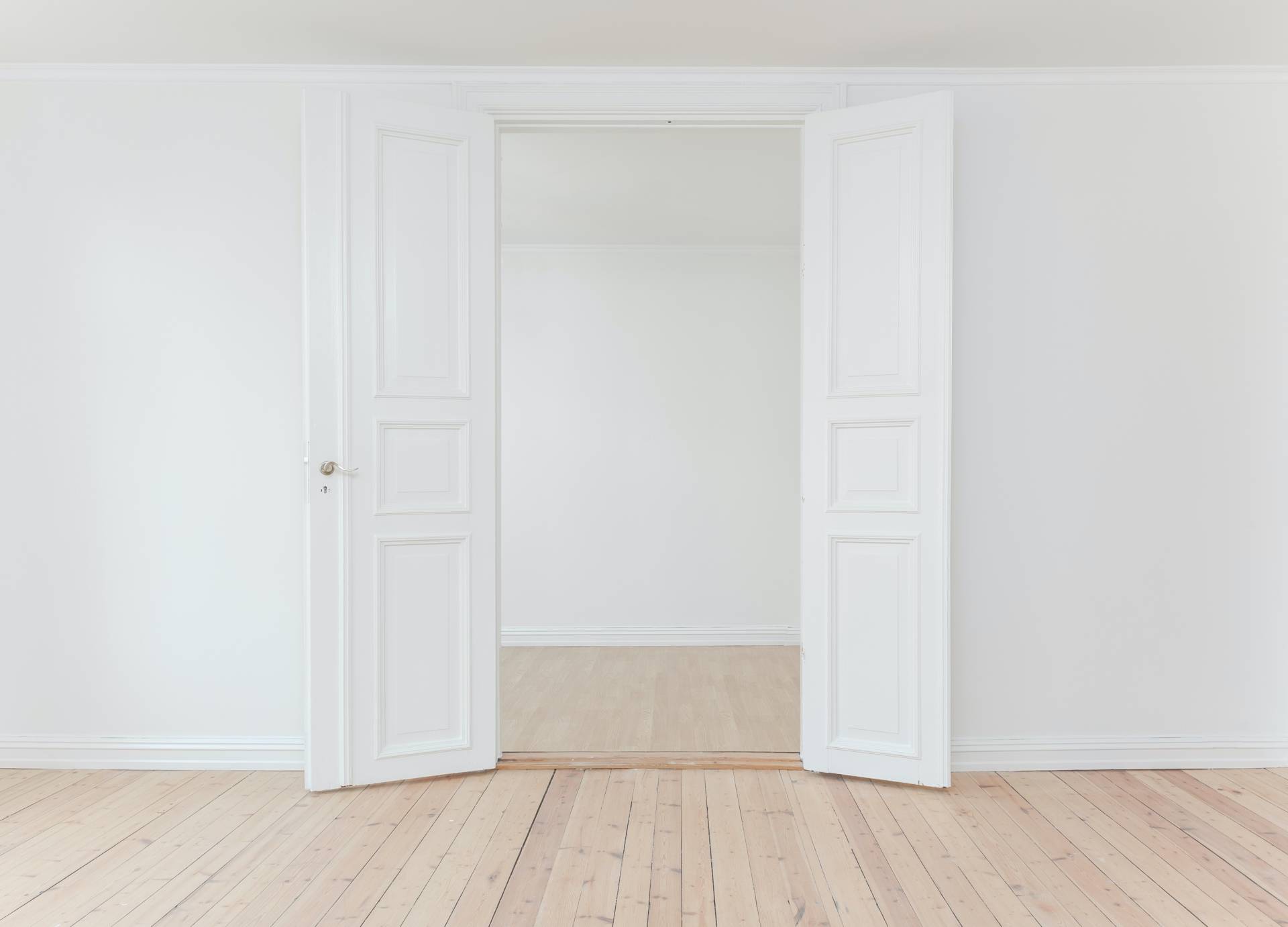 large white double doors open connecting two rooms