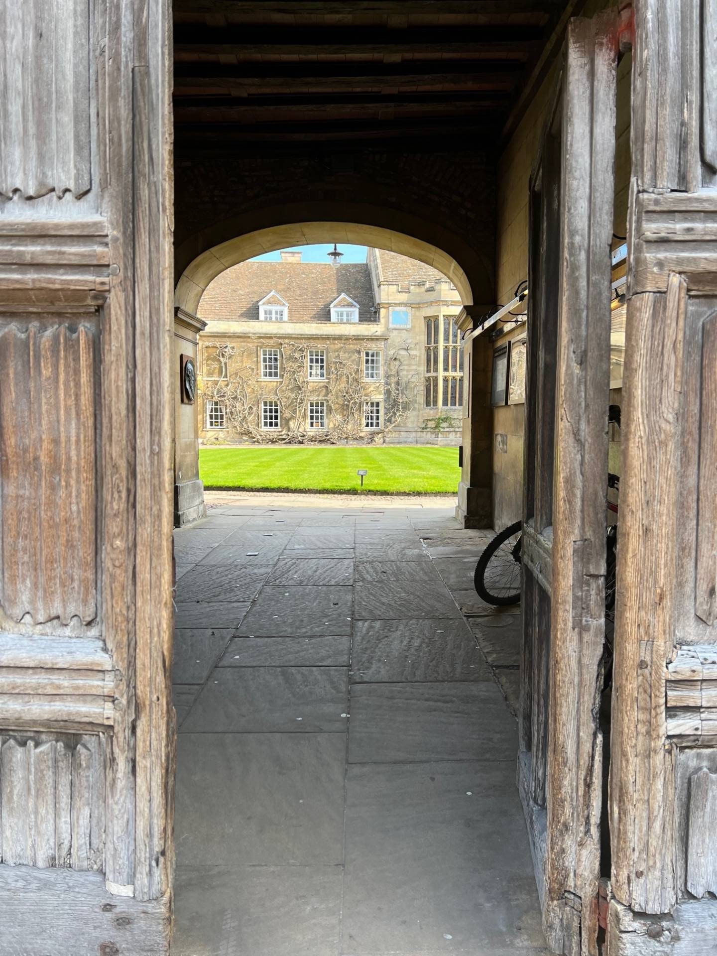 Open doorway to medieval grassed courtyard