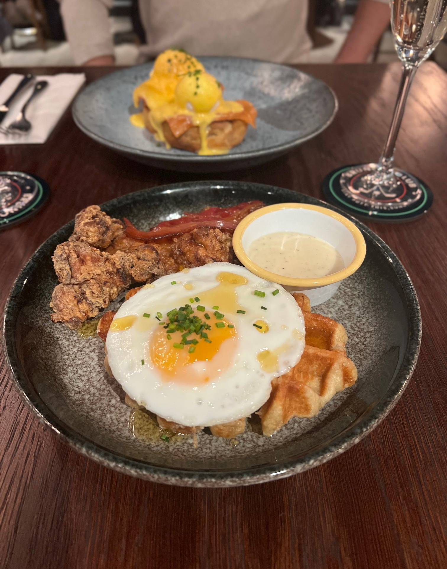 chicken waffles and egg on a blue plate