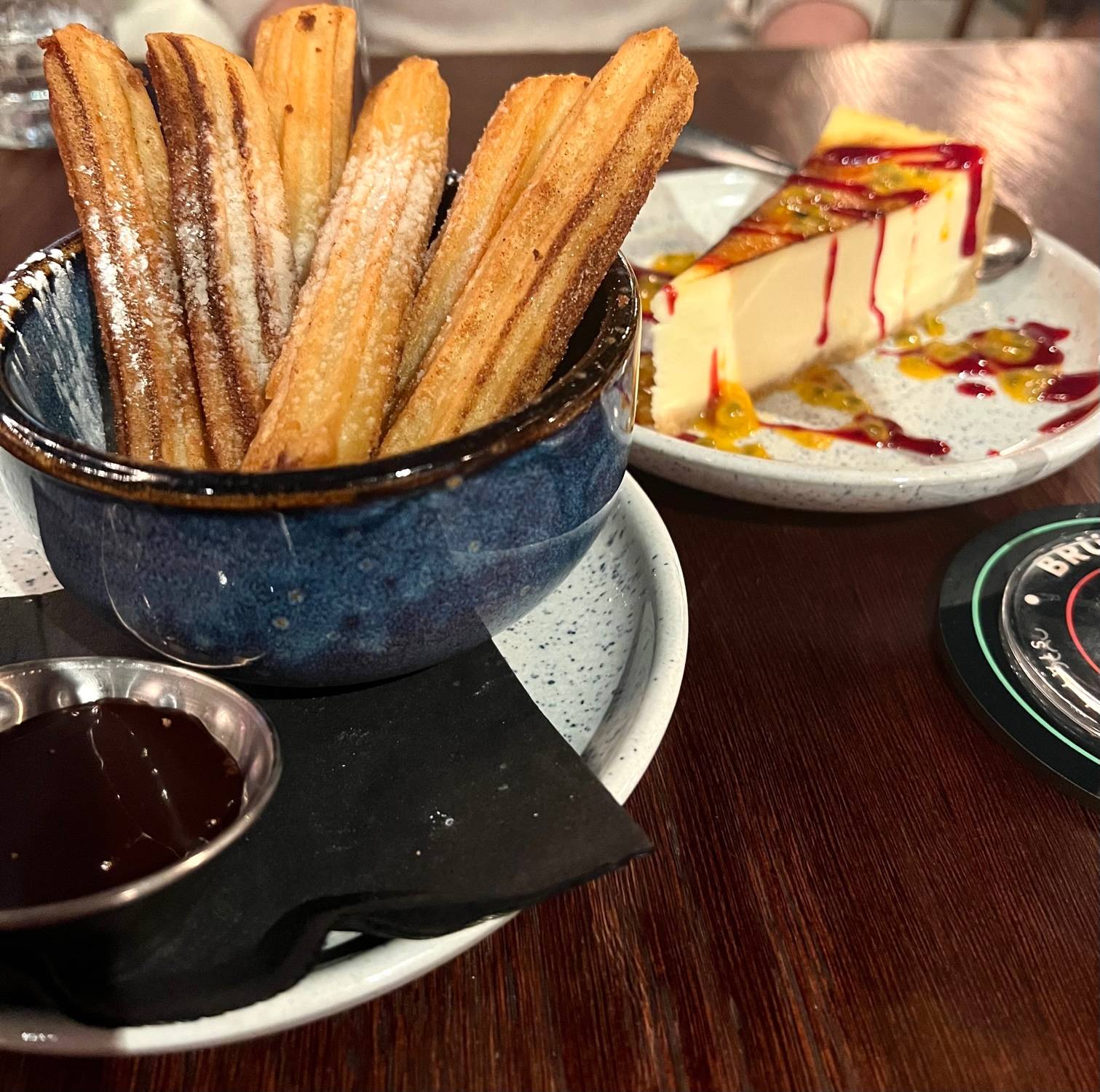 churros and cheesecake on blue plates