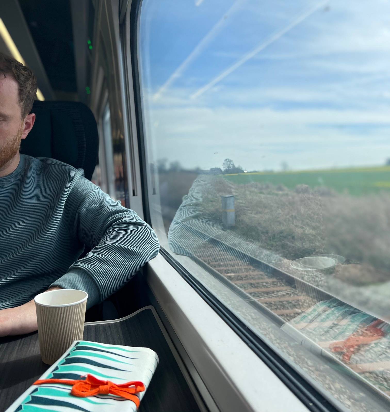 Interior shot of train and man with countryside 