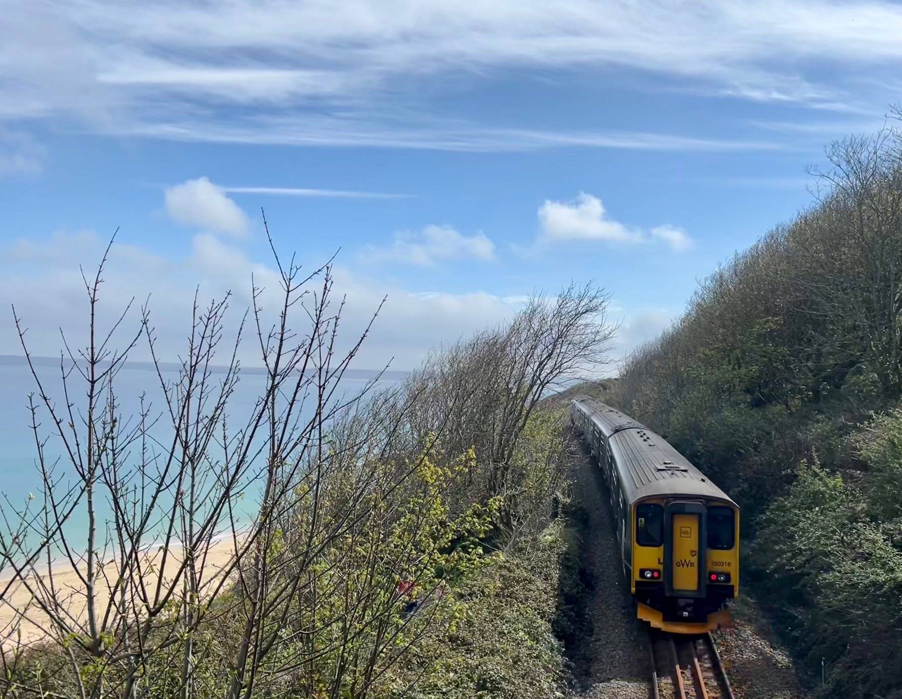 GWR train on track next to Cornish coast