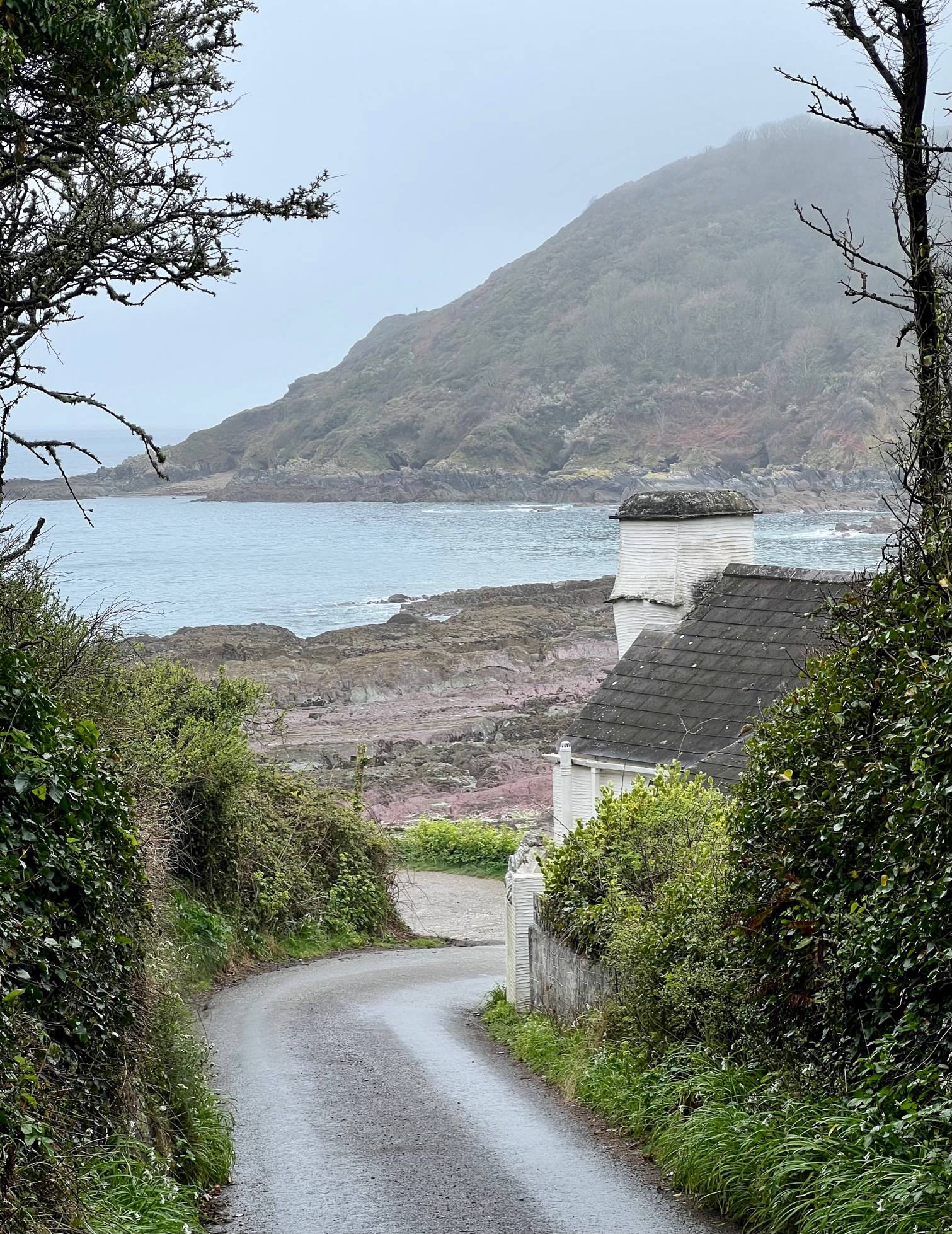 steep winding road down a coastal bay
